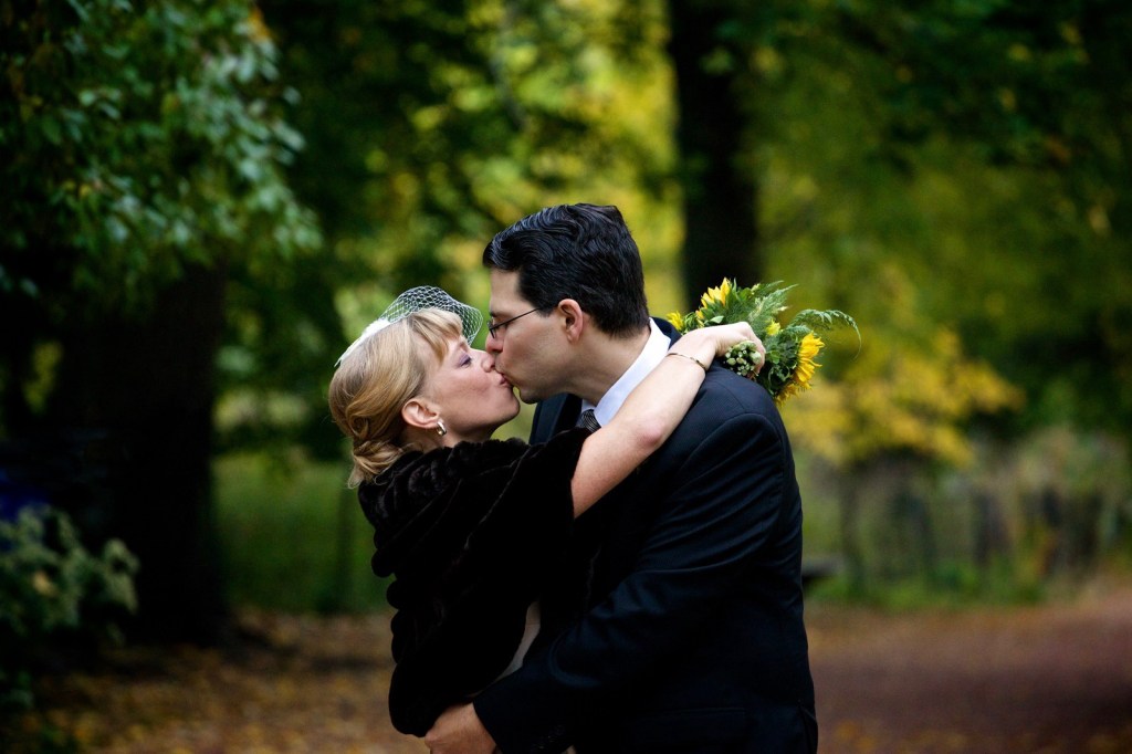 A couple sharing a kiss after the wedding in Lincoln Park, Chicago. 